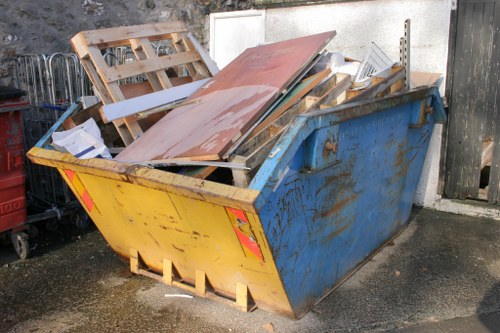 Construction workers clearing waste on a construction site in Sidcup
